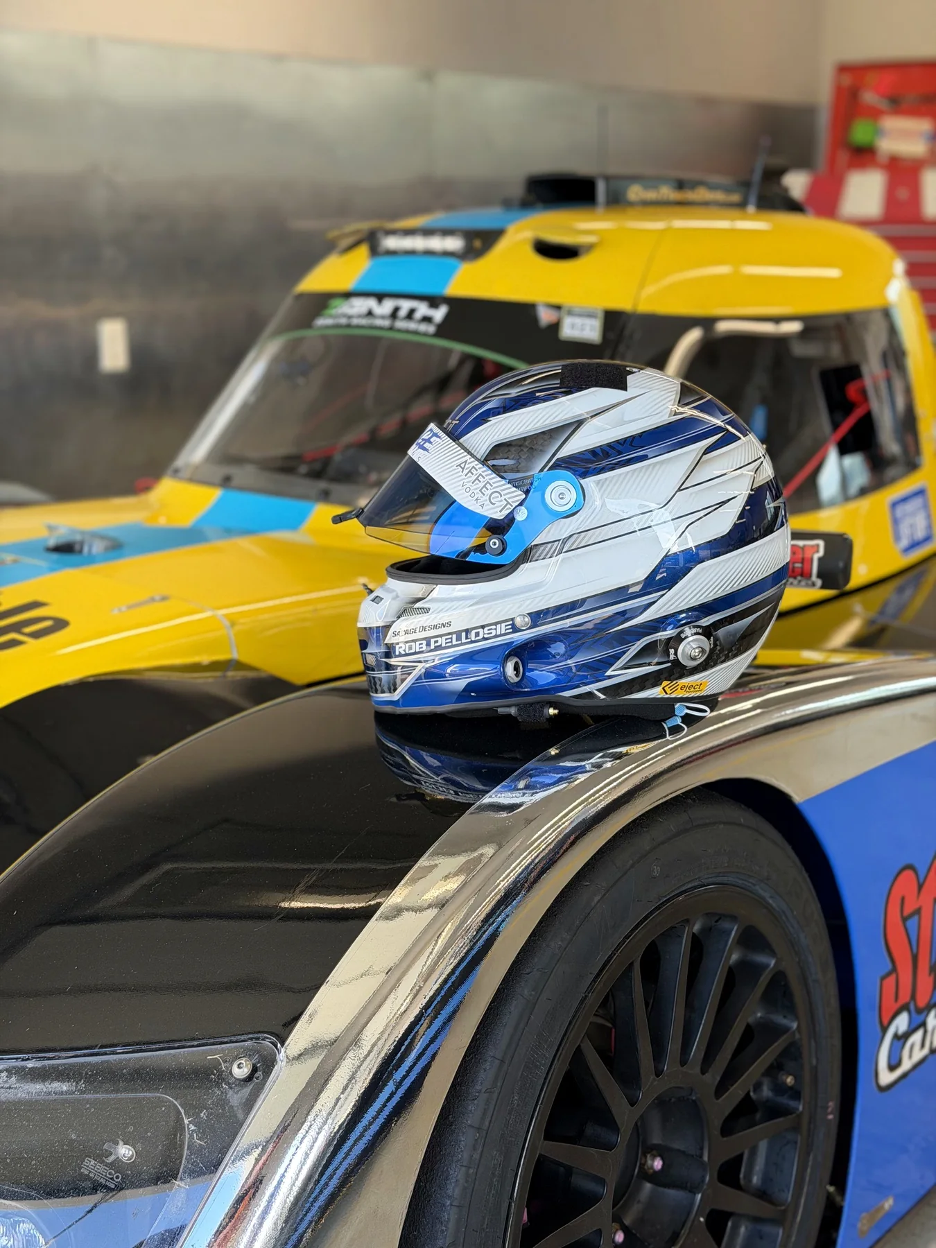 Rob Pellosie racing helmet resting on a race car
